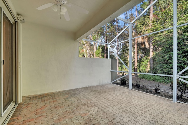 unfurnished sunroom featuring ceiling fan