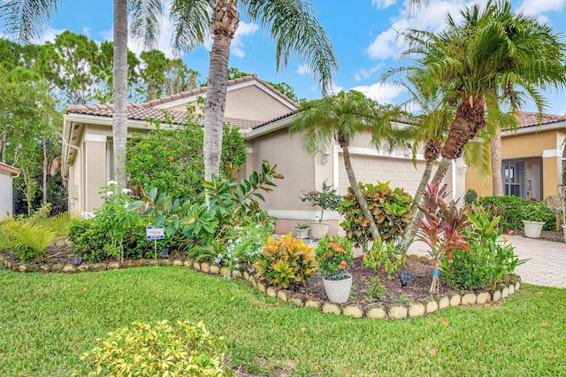 view of side of property with a garage and a lawn