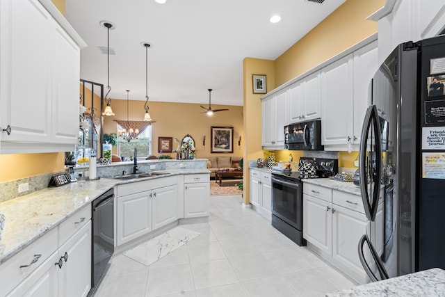 kitchen featuring black appliances, decorative light fixtures, white cabinetry, and sink