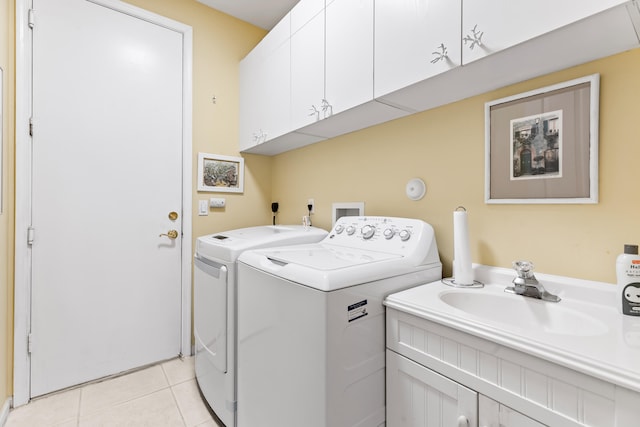 laundry area with cabinets, light tile patterned floors, separate washer and dryer, and sink