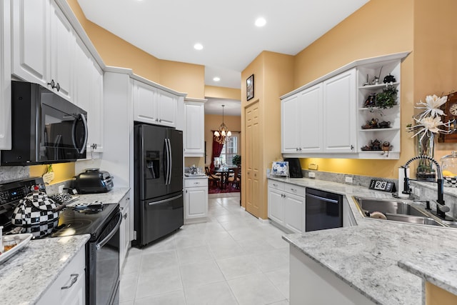 kitchen featuring white cabinetry, sink, an inviting chandelier, decorative light fixtures, and black appliances