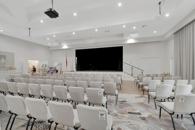 home theater featuring light hardwood / wood-style floors and a high ceiling