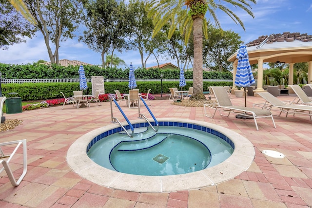 view of swimming pool with a community hot tub and a patio