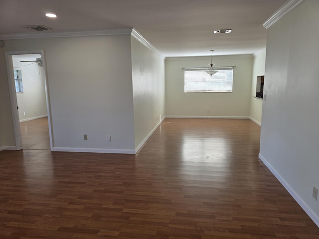 empty room with ceiling fan, dark wood-type flooring, and ornamental molding