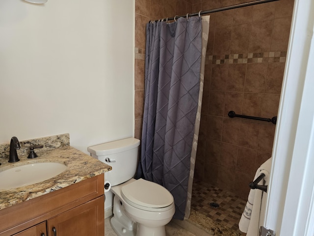 bathroom featuring curtained shower, vanity, and toilet