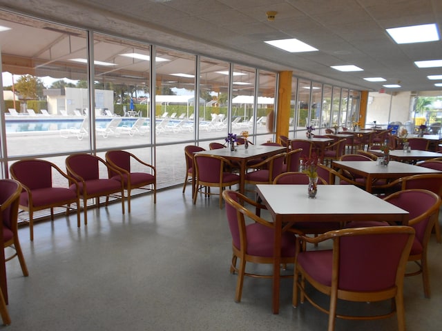 dining room featuring a drop ceiling