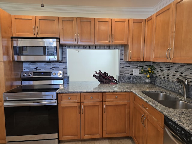 kitchen with sink, light stone counters, backsplash, appliances with stainless steel finishes, and ornamental molding