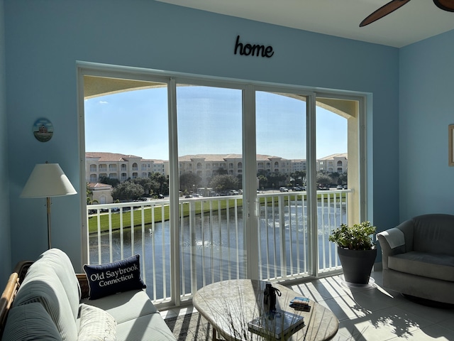 interior space featuring ceiling fan and a water view