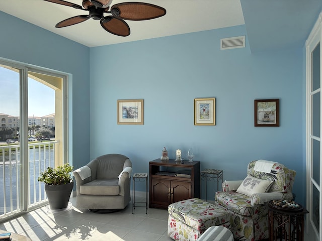 living area featuring ceiling fan and light tile patterned flooring