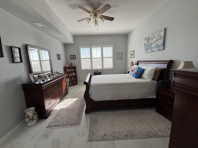 bedroom with multiple windows, ceiling fan, and a textured ceiling