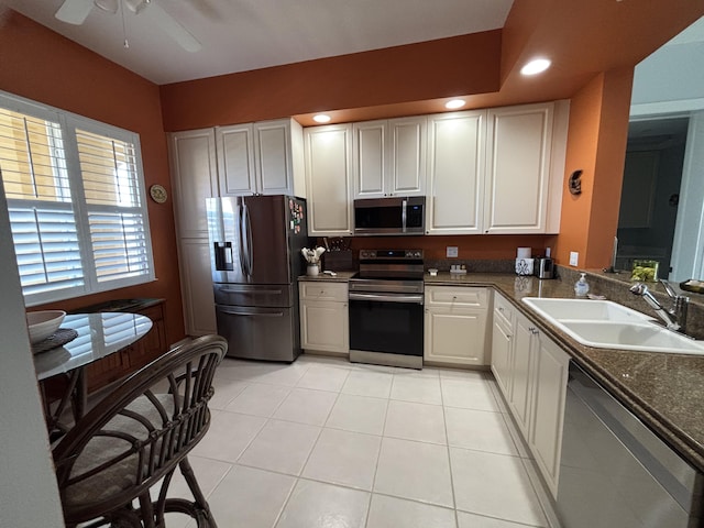 kitchen featuring light tile patterned flooring, sink, white cabinetry, and stainless steel appliances