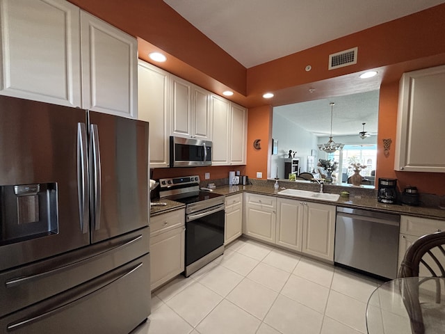 kitchen with sink, white cabinets, stainless steel appliances, and light tile patterned floors