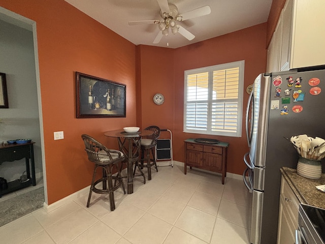 dining area featuring ceiling fan and light tile patterned floors