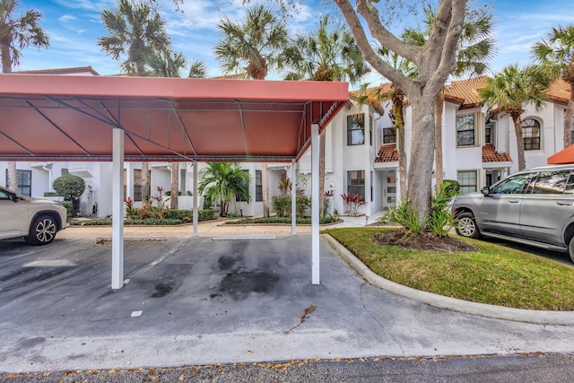 view of vehicle parking featuring a carport