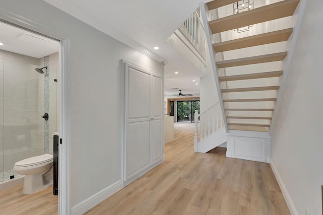 hall featuring crown molding and light hardwood / wood-style floors