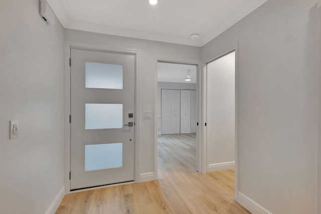 interior space with light hardwood / wood-style floors and crown molding