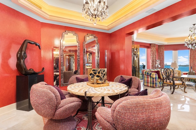 dining space featuring a chandelier, a water view, a raised ceiling, and ornamental molding