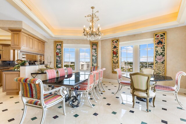 dining room with a notable chandelier, a healthy amount of sunlight, light tile patterned floors, and a tray ceiling