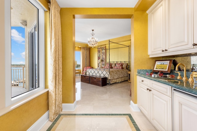 bedroom with light tile patterned flooring and a notable chandelier