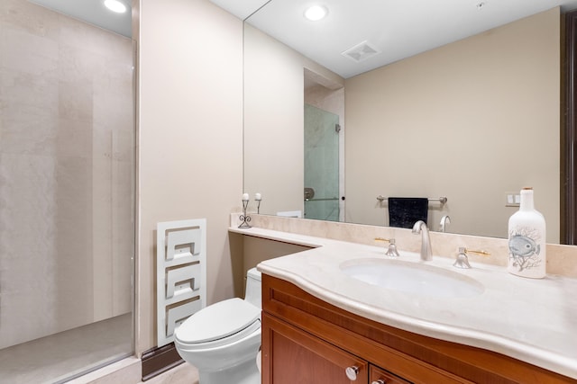 bathroom featuring a shower with door, vanity, and toilet