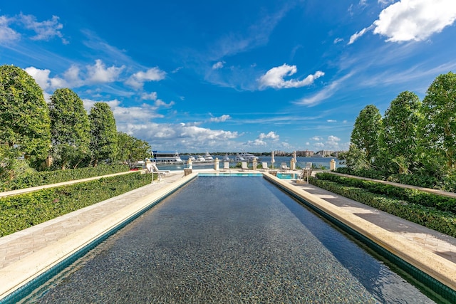 view of pool featuring a water view