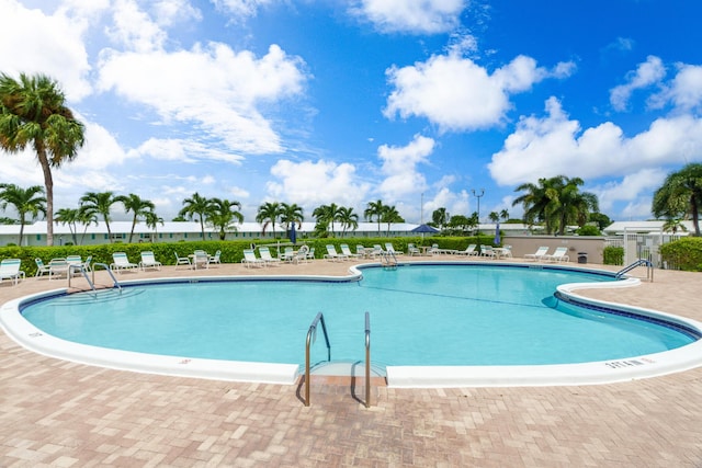 community pool featuring a patio area and fence