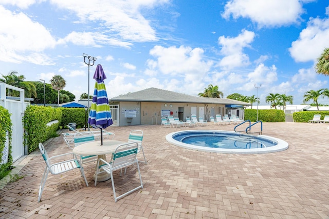 view of pool with a patio area, fence, and a swimming pool