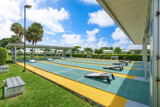 view of home's community featuring shuffleboard and a yard