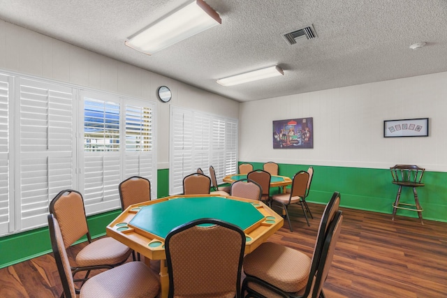 playroom featuring a textured ceiling, wood finished floors, and visible vents