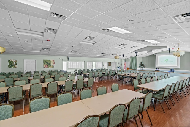 dining space featuring hardwood / wood-style flooring and a drop ceiling