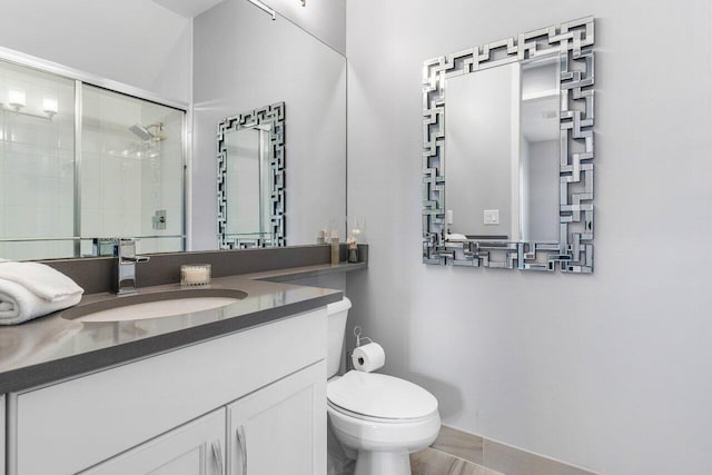 bathroom featuring vanity, toilet, and walk in shower