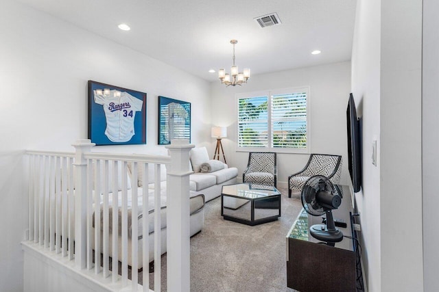 carpeted living room featuring a notable chandelier