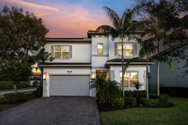 view of front of property with a lawn and a garage