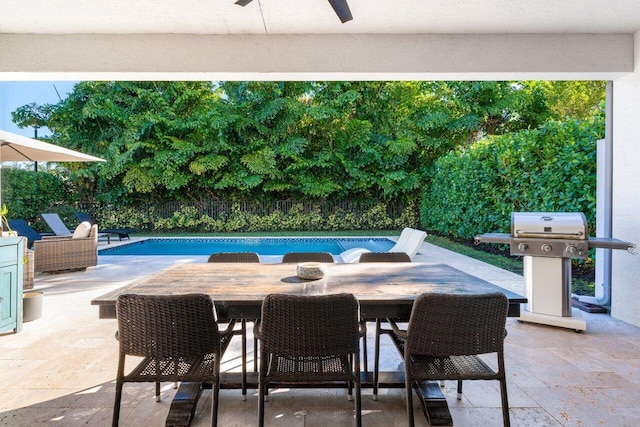 view of swimming pool with a grill, ceiling fan, and a patio