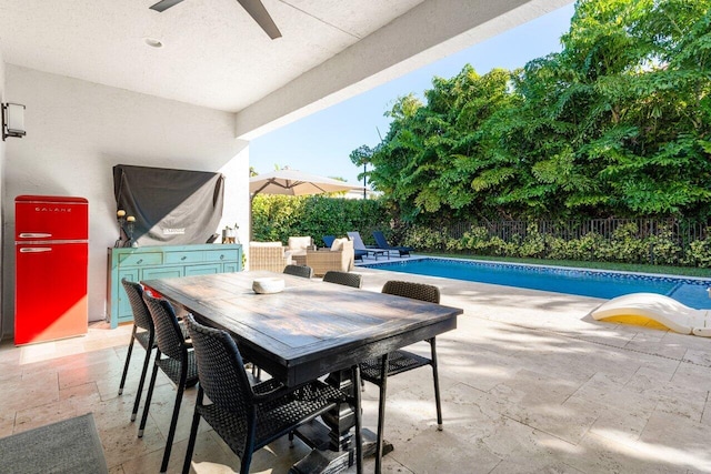 view of patio / terrace featuring a fenced in pool and ceiling fan