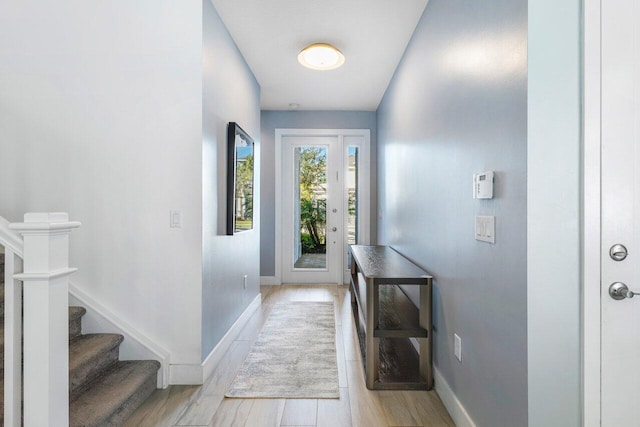 doorway to outside with light wood-type flooring