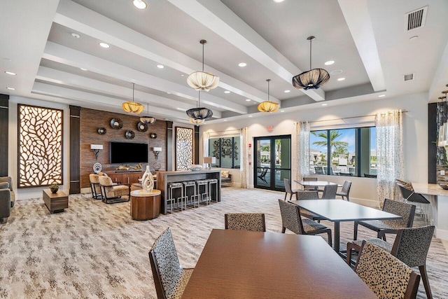 dining area with beamed ceiling and french doors