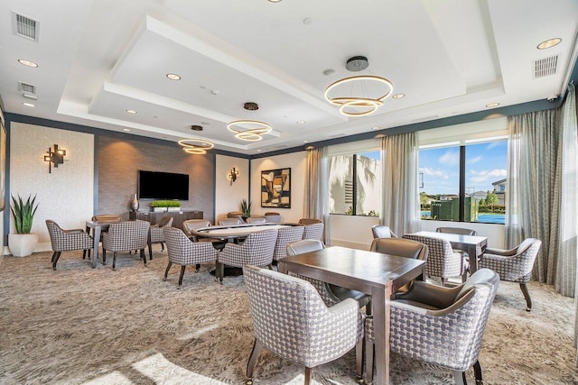 dining room featuring a raised ceiling