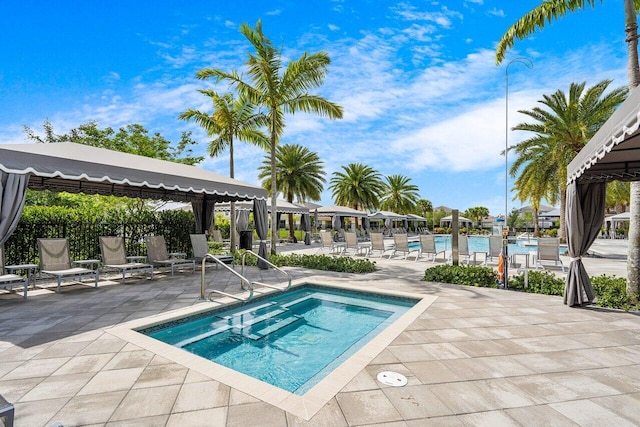 view of swimming pool featuring a gazebo and a patio area