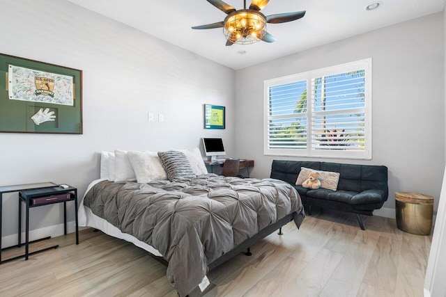 bedroom with light hardwood / wood-style flooring and ceiling fan