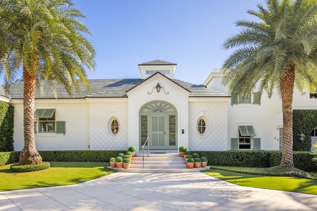 mediterranean / spanish home featuring french doors