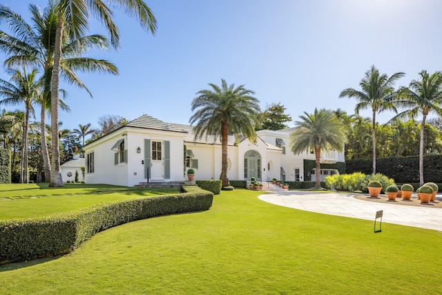 mediterranean / spanish home with a front yard