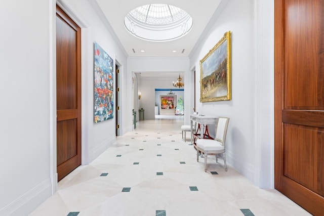 corridor featuring a chandelier and crown molding