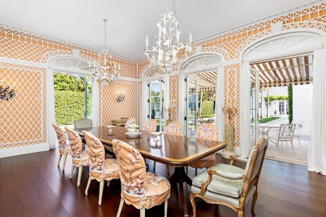 dining area with a notable chandelier, dark hardwood / wood-style flooring, and ornamental molding