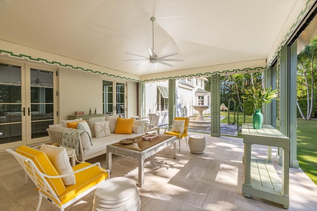 sunroom / solarium with french doors, a wealth of natural light, and ceiling fan