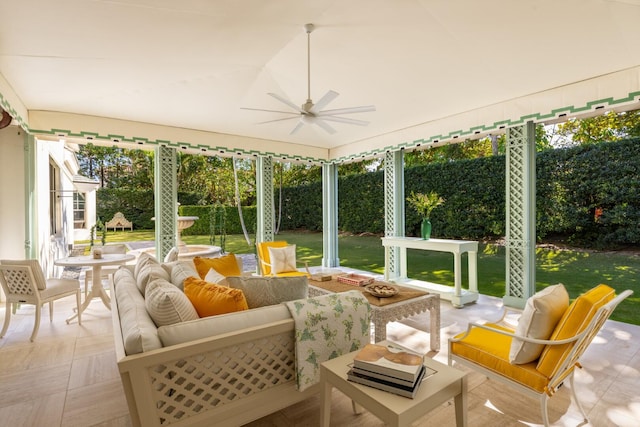 sunroom featuring ceiling fan