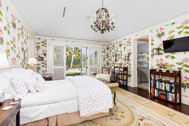 bedroom featuring dark hardwood / wood-style flooring, a chandelier, and ornamental molding