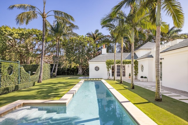 view of pool with a yard