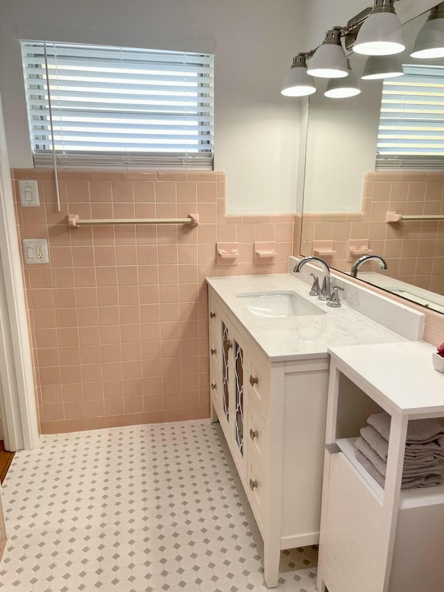 bathroom featuring tile patterned flooring, vanity, and tile walls