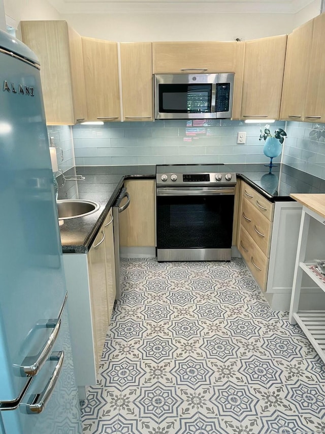 kitchen featuring sink, appliances with stainless steel finishes, backsplash, and light brown cabinets